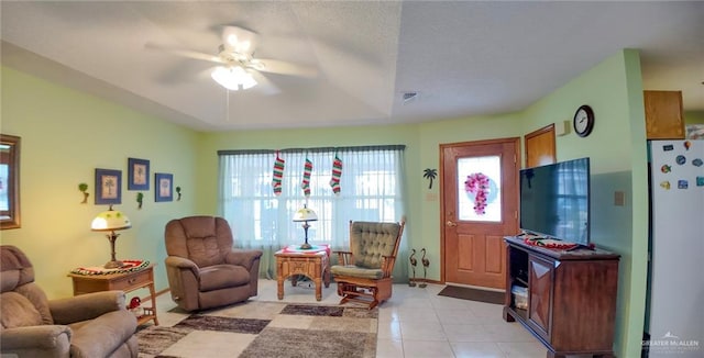 tiled living room with ceiling fan