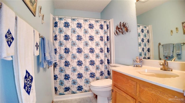 bathroom with a shower with curtain, vanity, a textured ceiling, and toilet