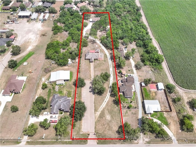 birds eye view of property with a rural view