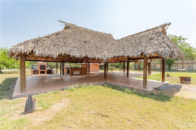 view of community featuring a gazebo, a yard, and a patio