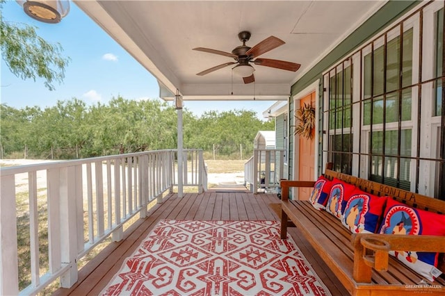 deck featuring an outdoor living space and ceiling fan