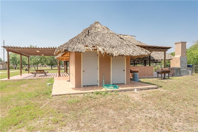 back of house with a pergola, a patio, and a yard