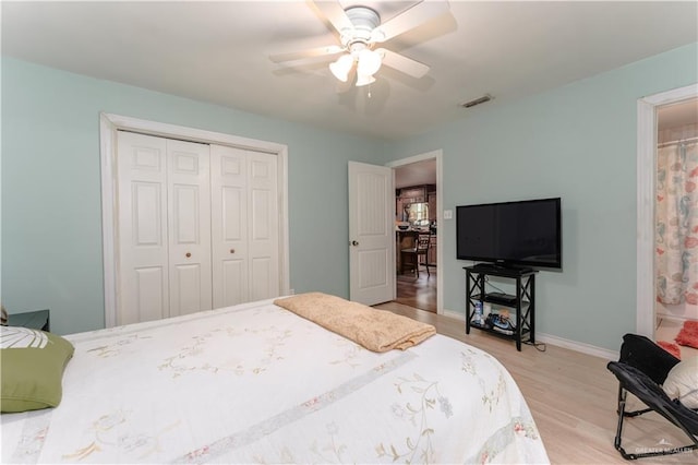 bedroom with ceiling fan, a closet, and light wood-type flooring