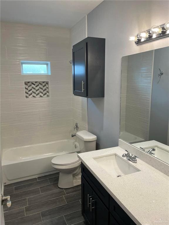 full bathroom with vanity, toilet, and tiled shower / bath