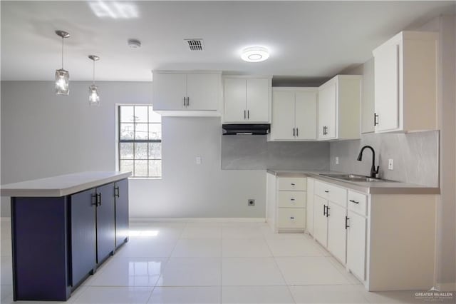 kitchen featuring white cabinets, light countertops, and decorative light fixtures