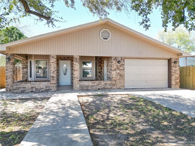 view of front of house featuring a garage, concrete driveway, brick siding, and fence