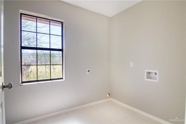 washroom featuring light tile patterned floors, hookup for a washing machine, hookup for an electric dryer, laundry area, and baseboards