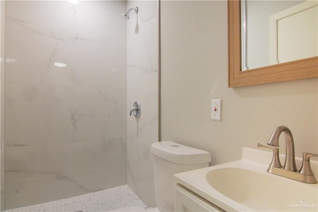 full bathroom featuring vanity, a marble finish shower, and toilet