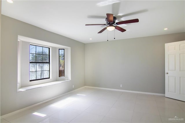 spare room with light tile patterned floors, recessed lighting, a ceiling fan, and baseboards