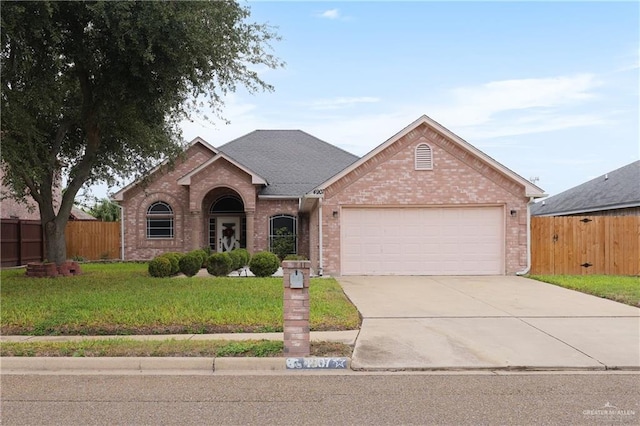 view of front of property with a garage and a front lawn