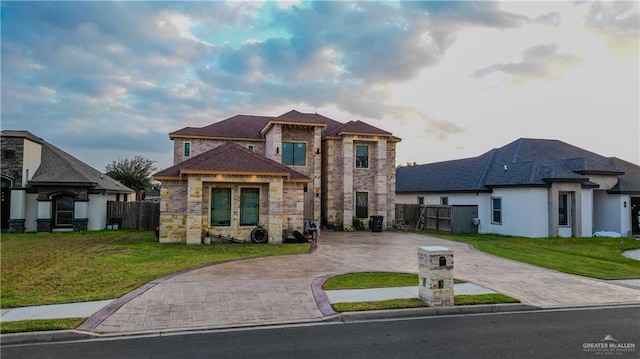 view of front of home with french doors and a front lawn