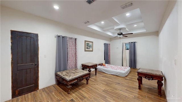 bedroom with beamed ceiling, light hardwood / wood-style floors, ceiling fan, and coffered ceiling