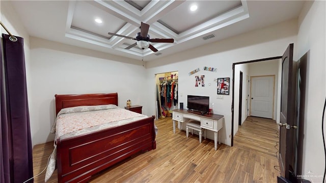 bedroom featuring hardwood / wood-style floors, coffered ceiling, ceiling fan, beamed ceiling, and a closet