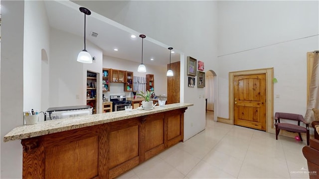 kitchen featuring light stone countertops, kitchen peninsula, stainless steel electric stove, a high ceiling, and hanging light fixtures