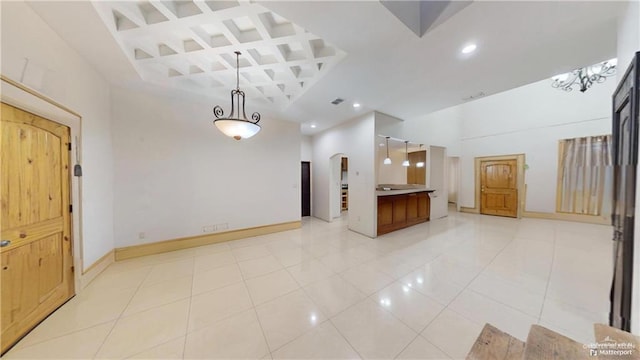 interior space with pendant lighting and light tile patterned flooring