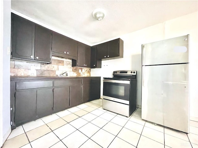 kitchen with backsplash, sink, dark brown cabinets, light tile patterned flooring, and stainless steel appliances