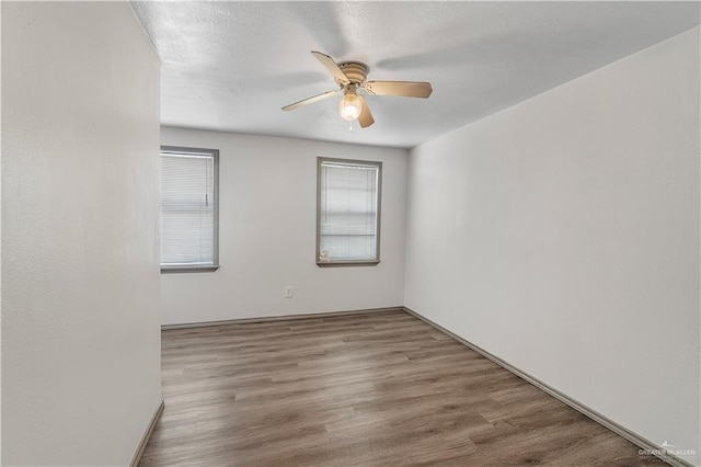 empty room featuring light wood-type flooring and ceiling fan