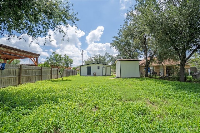 view of yard featuring a pergola and a storage shed