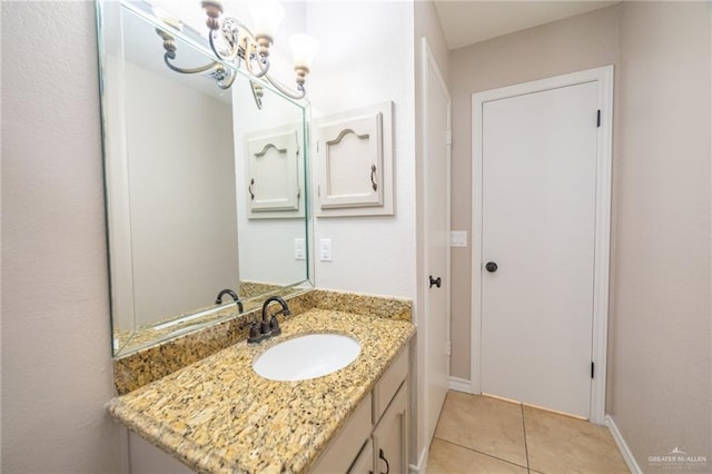 bathroom featuring tile patterned flooring, vanity, and an inviting chandelier