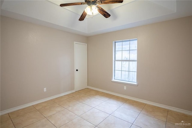 tiled empty room featuring ceiling fan