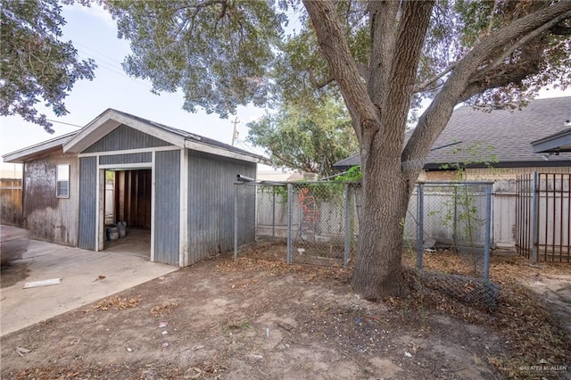 rear view of property with an outdoor structure