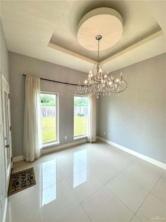2301 Mcleod Ave, Edinburg, TX 78539 - tiled spare room featuring a chandelier and a raised ceiling