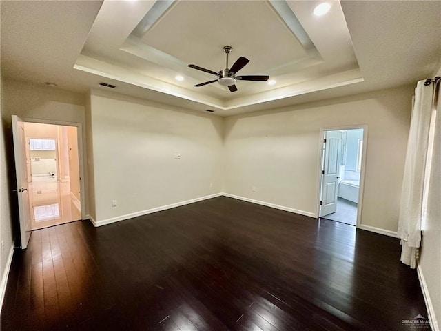 2301 Mcleod Ave, Edinburg, TX 78539 - empty room featuring a tray ceiling, a ceiling fan, dark wood-style floors, and recessed lighting