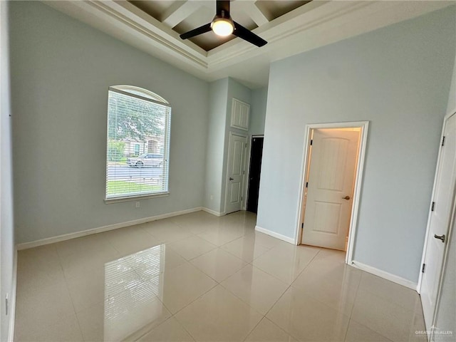 2301 Mcleod Ave, Edinburg, TX 78539 - unfurnished bedroom featuring coffered ceiling, a high ceiling, beam ceiling, light tile patterned flooring, and a ceiling fan