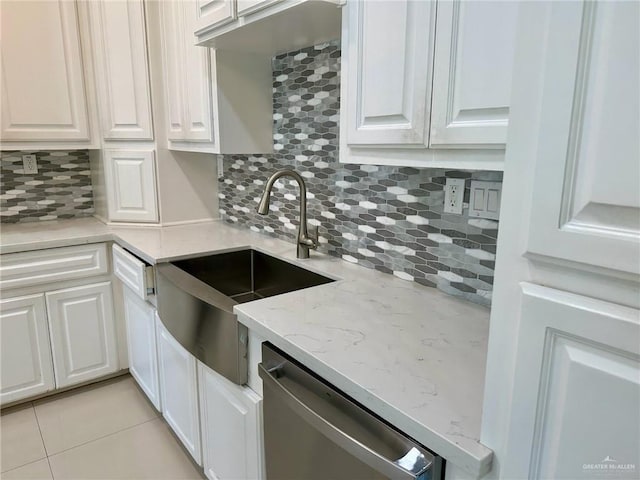 2301 Mcleod Ave, Edinburg, TX 78539 - kitchen featuring stainless steel dishwasher, white cabinets, backsplash, and light stone counters