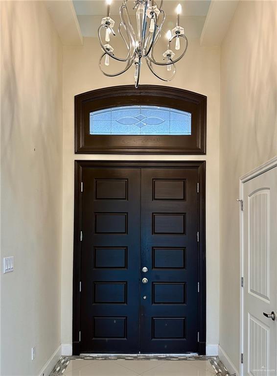 2301 Mcleod Ave, Edinburg, TX 78539 - entryway featuring a chandelier and marble finish floors