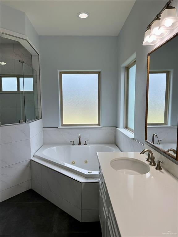 2301 Mcleod Ave, Edinburg, TX 78539 - bathroom with a whirlpool tub, vanity, a shower stall, and recessed lighting