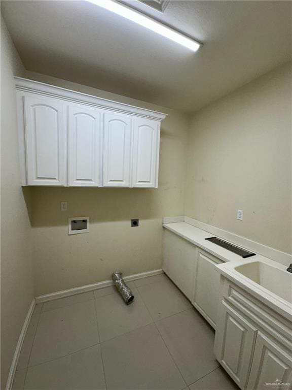 2301 Mcleod Ave, Edinburg, TX 78539 - laundry area with electric dryer hookup, cabinet space, washer hookup, and light tile patterned flooring