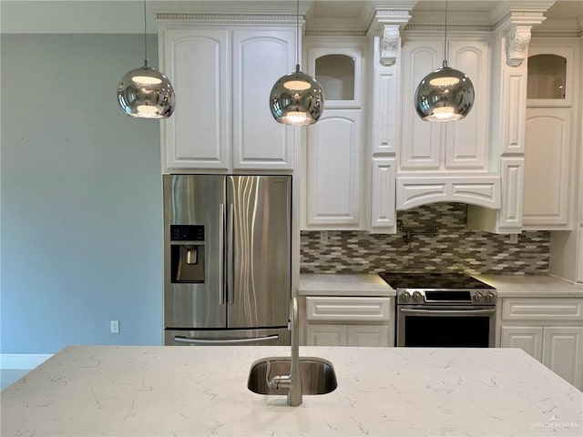 2301 Mcleod Ave, Edinburg, TX 78539 - kitchen featuring appliances with stainless steel finishes, glass insert cabinets, tasteful backsplash, and white cabinetry