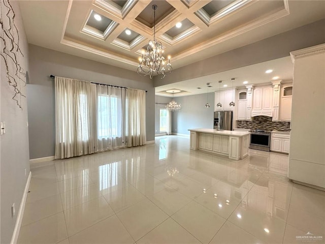 2301 Mcleod Ave, Edinburg, TX 78539 - kitchen featuring a chandelier, stainless steel appliances, ornamental molding, decorative backsplash, and hanging light fixtures