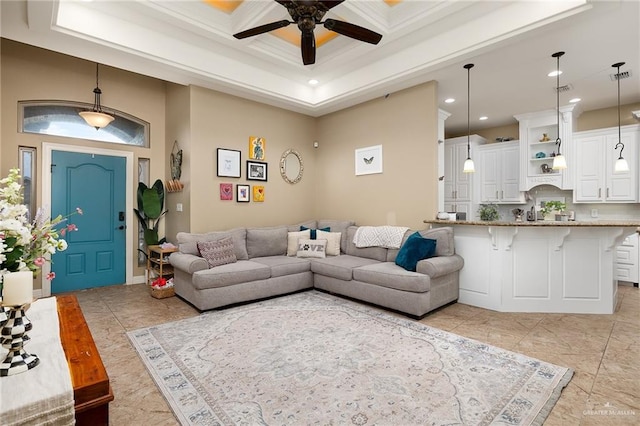 living room featuring a towering ceiling, ceiling fan, coffered ceiling, beamed ceiling, and crown molding