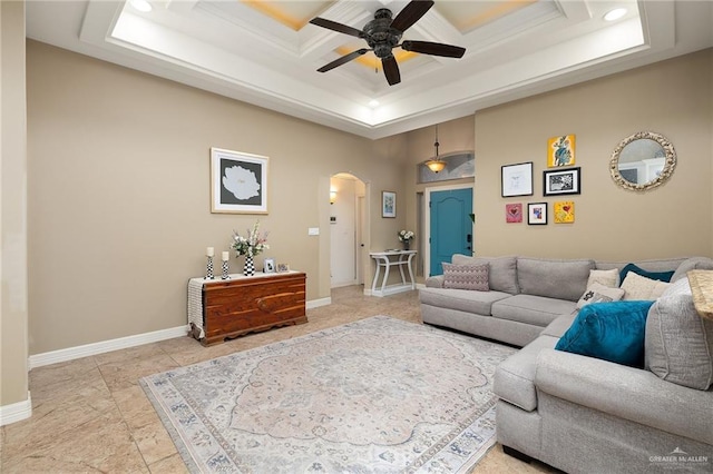 living room with ornamental molding and ceiling fan