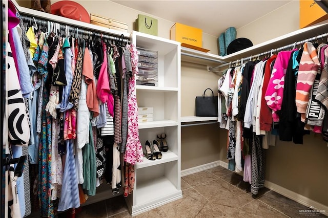 walk in closet with tile patterned flooring