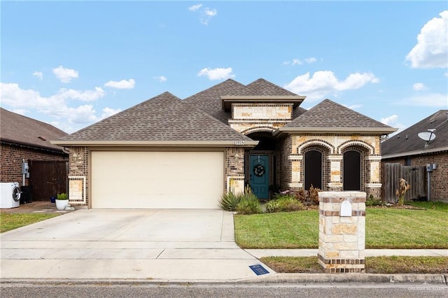 view of front of house with a garage and a front lawn