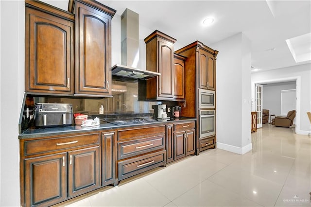 kitchen with decorative backsplash, wall chimney exhaust hood, stainless steel appliances, and light tile patterned floors