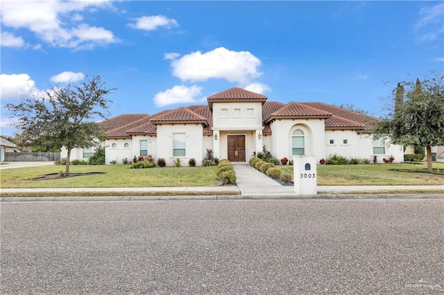 mediterranean / spanish-style house with a front lawn