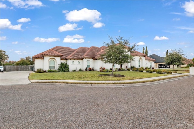 mediterranean / spanish-style house featuring a front lawn