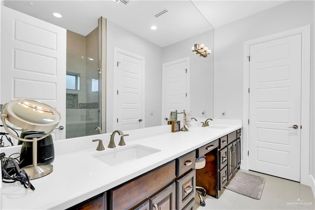 bathroom featuring tile patterned flooring, vanity, and walk in shower