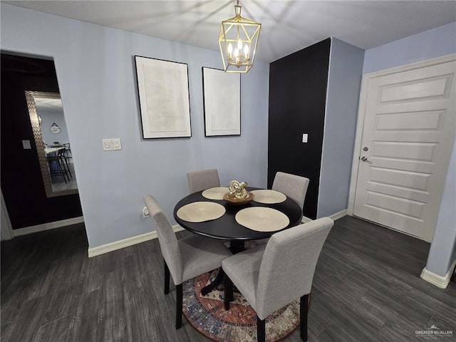 dining area featuring dark hardwood / wood-style flooring and a chandelier