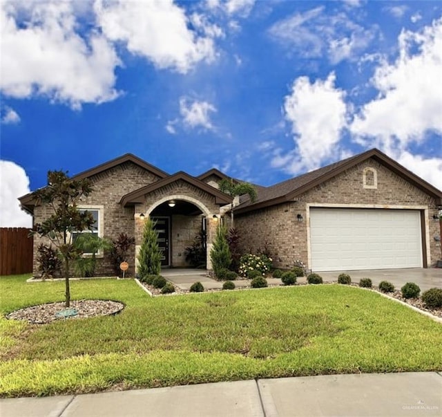 single story home featuring a garage and a front yard