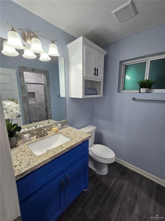 bathroom with vanity, hardwood / wood-style floors, toilet, and walk in shower