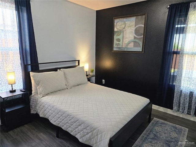 bedroom with dark wood-type flooring