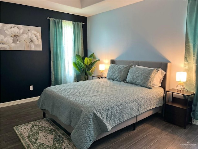 bedroom with dark wood-type flooring