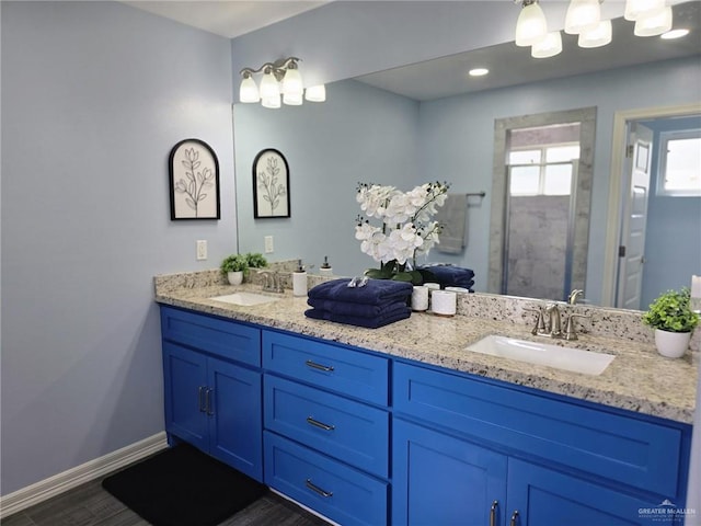 bathroom with vanity, hardwood / wood-style floors, and a shower with shower door