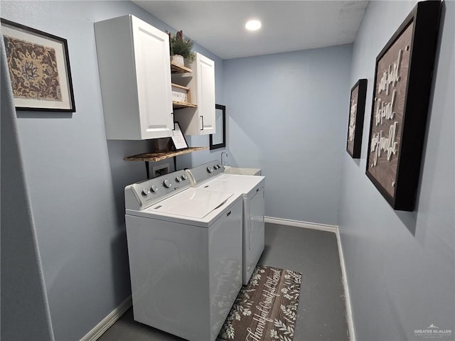 laundry area with washer and clothes dryer and cabinets