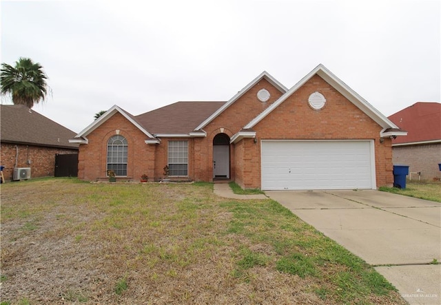 single story home with a garage, concrete driveway, a front lawn, central AC, and brick siding